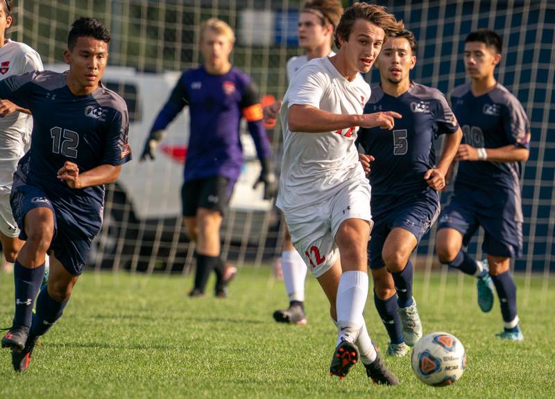Oswego’s Ryan Walsh (12) plays the ball on a fast break against Oswego East during a soccer match at Oswego East High School on Monday, Sep 26, 2022.