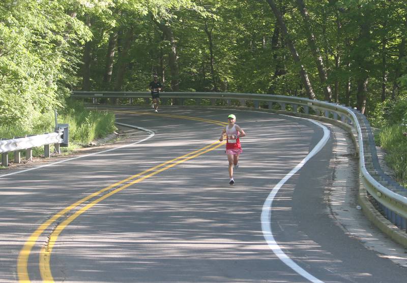 Runners jog down a portion of Illinois Route 71 during the Starved Rock Marathon and Half Marathon on Saturday, May 11, 2024 at Starved Rock State Park.