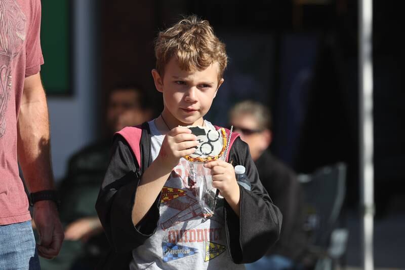James Fite, 9, from Plainfield eats a Harry Potter cookie as he walks along Liberty Street at the Magic in Morris event on Saturday.
