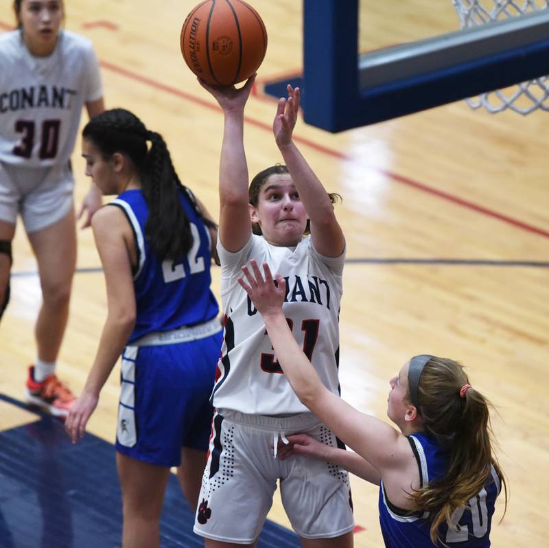 Conant's Aria Mazza takes a shot over Geneva's Caroline Madden (20) during Friday’s IHSA Class 4A girls basketball regional championship in Hoffman Estates.