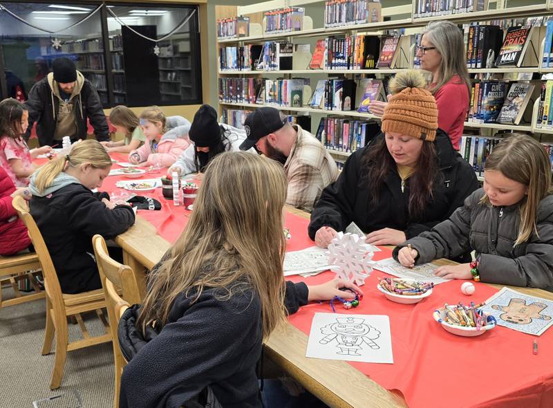 Families take part in a coloring activity Saturday, Dec. 14, 2024, at the Oglesby Public Library during Oglesby's Winter Wonderland activities.