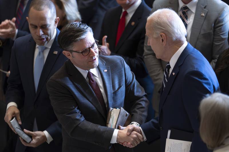 FILE - President Joe Biden, shakes hands with House Speaker Mike Johnson of La., joined at left by House Minority Leader Hakeem Jeffries, D-N.Y., at the conclusion of the National Prayer Breakfast, Feb. 1, 2024, at the Capitol in Washington. Biden is meeting with the top four leaders of Congress to press for quick action to avoid a looming government shutdown and send emergency aid to Ukraine and Israel. Biden is hosting House Speaker Mike Johnson, Senate Majority Leader Chuck Schumer, House Minority Leader Hakeem Jeffries and Senate Minority Leader Mitch McConnell in the Oval Office on Tuesday. (AP Photo/J. Scott Applewhite, File)