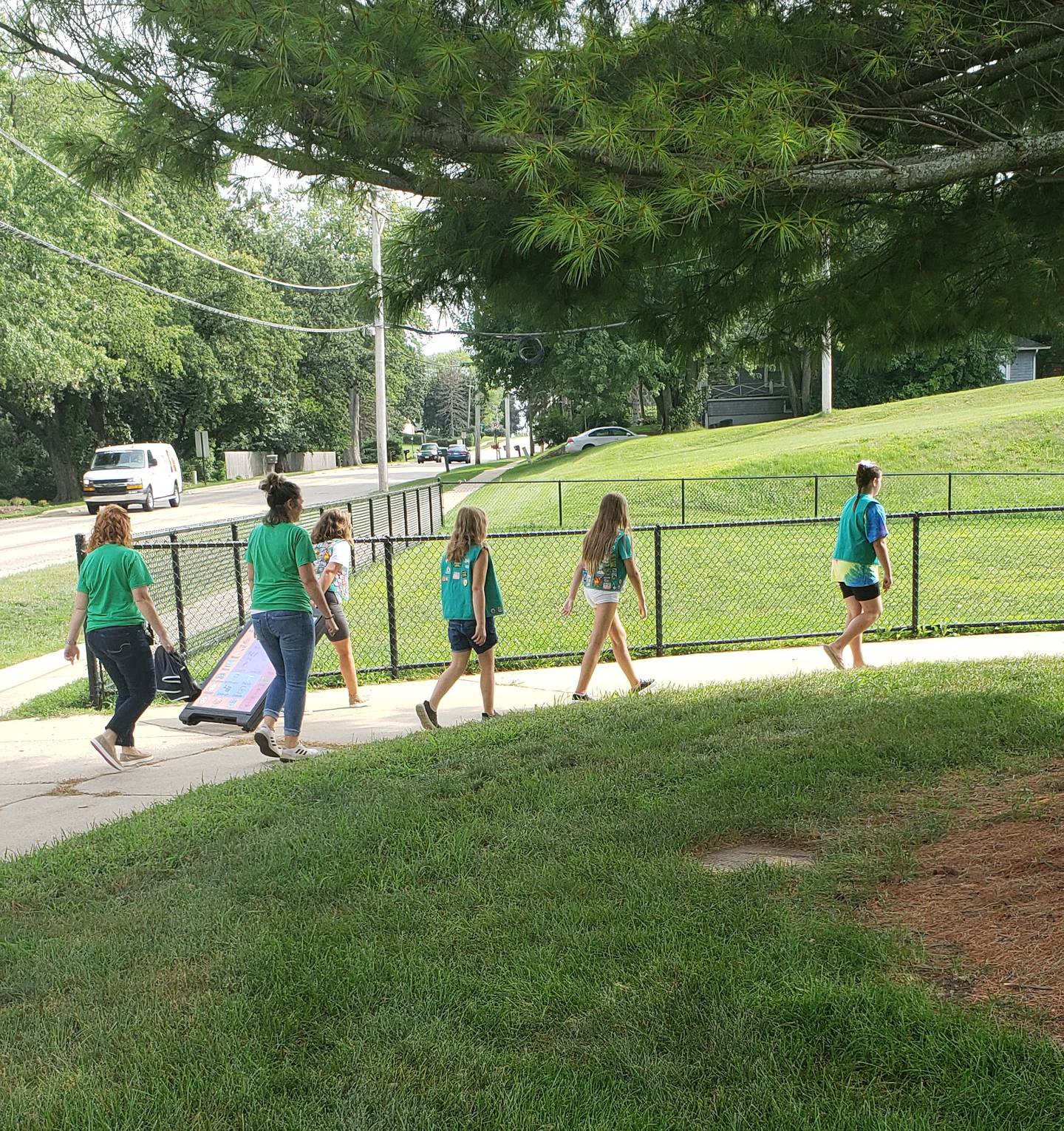 Girl Scouts from McHenry Troop 360 roll the A-frame communications signs to each of the two playgrounds at Edgebrook Elementary School on Monday, Aug. 15, 2022.