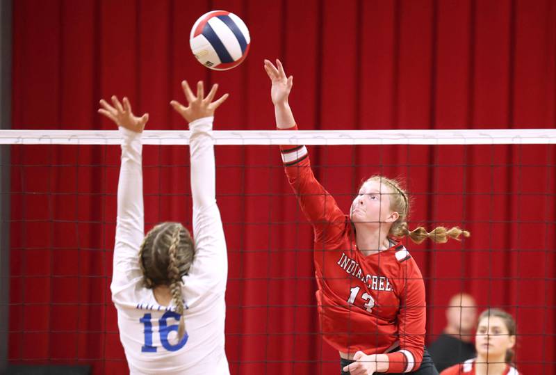 Indian Creek's Allie Peterson tries to spike the ball by Hinckley-Big Rock's Grace Barrett during their match Tuesday, Sept. 19, 2023, at Indian Creek High School in Shabbona.