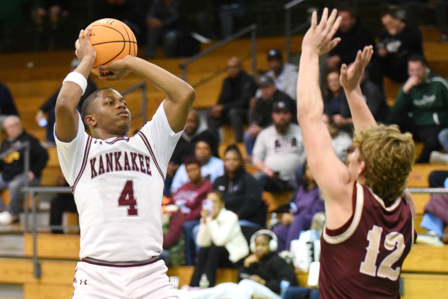 Kankakee's Myair Thompson, left, shoots as Morris' Caden Medler defends during the IHSA Class 3A Geneseo Regional semifinals Wednesday, Feb. 25, 2026.