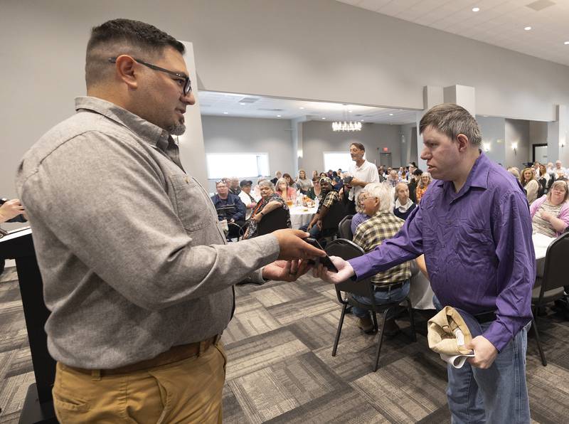 Self Help client John Roberson (right) accepts the Most Improved Personality Award from board president Dan Rodriguez Thursday, Oct. 16, 2025, during the annual Self Help Awards.