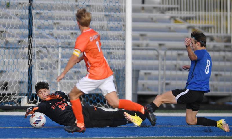 St. Charles East goalkeeper Jordan Rolon stops a St. Charles North shot in the TriCities boys soccer night game in Geneva on Tuesday, September 27, 2022.