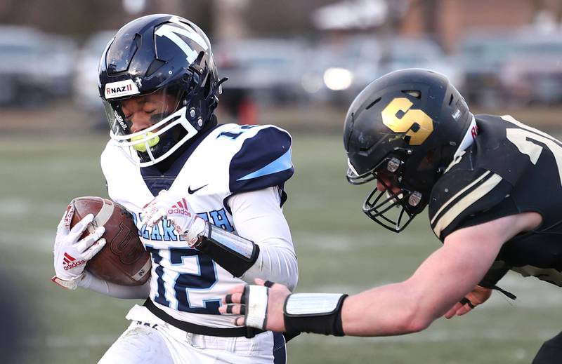 Nazareth's Eddie Mcclain Jr. is pushed out of bounds by Sycamore's Ethan Bode Saturday, Nov. 18, 2022, during their state semifinal game at Sycamore High School.