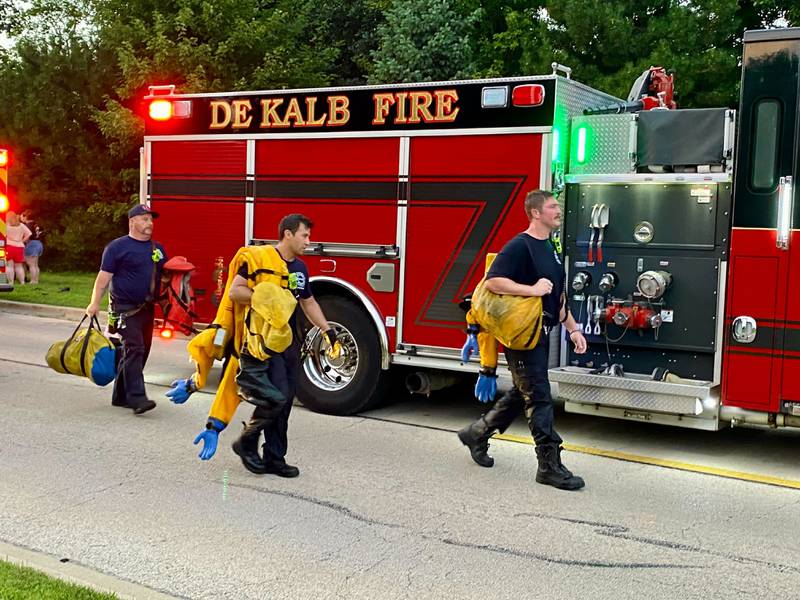 Firefighters gear up to help with a water rescue on Sunday, July 27, 2025, in the 600 block of Ridge Drive in DeKalb.
