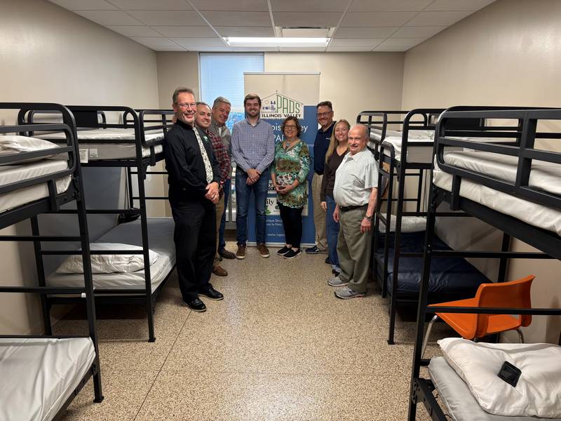 (From left) Rotarians Stan Wolf and Christian Zamin, Illinois Valley Sunrise Rotary President Elect Mark Ptak, Illinois Valley Sunrise Rotary President Tony Bacidore, Illinois Valley Public Action to Deliver Shelter Executive Director Carol Alcorn, and Rotarians Jason Curran, Beth Coleman and Dr. John Lavieri gather after Rotarians made a contribution to the Peru homeless shelter.