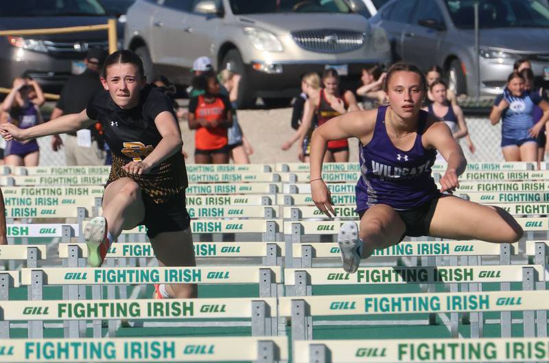 Reed Custer's Alyssa Wollenzien races Wilmington's McKenna Van Tilburg in the 100 meter hurdles during the Class 1A Sectional meet on Thursday, May 14, 2026 at Seneca High School.