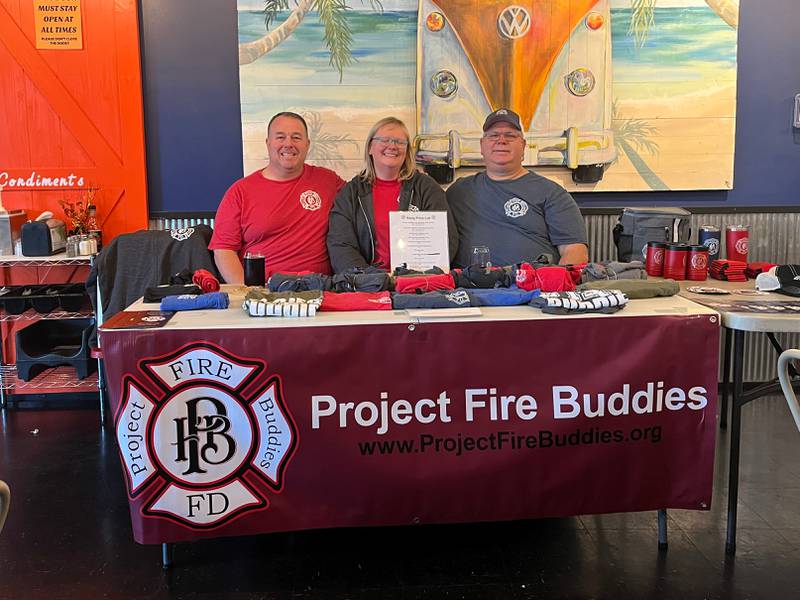 Lockport Township Fire District Lieutenant Tom, left, and his wife Kim Clifton along with volunteer Mark Sikorski poses for a photo at the Project Fire Buddies fundraising table.