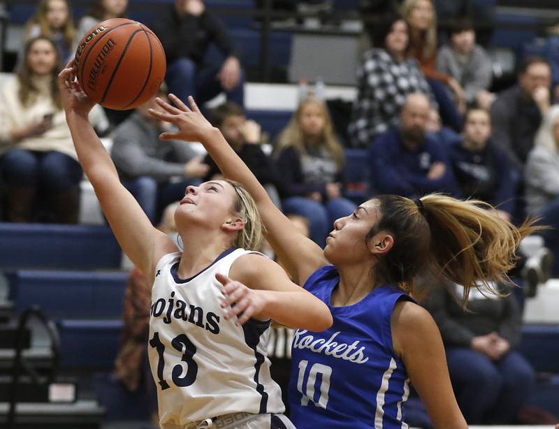 Cary-Grove's Malaina Kurth tries to grab a rebound in front of Burlington Central's Samantha Origel during a Fox Valley Conference girls basketball game Friday Jan. 6, 2023, at Cary-Grove High School in Cary.