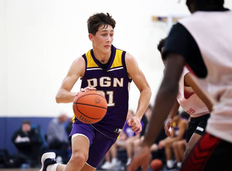 Downers Grove North's Jack Stanton (21) drives to the basket against Bolingbrook during the Riverside Brookfield Shootout for boys varsity basketball in Riverside on Friday, June 16, 2023.