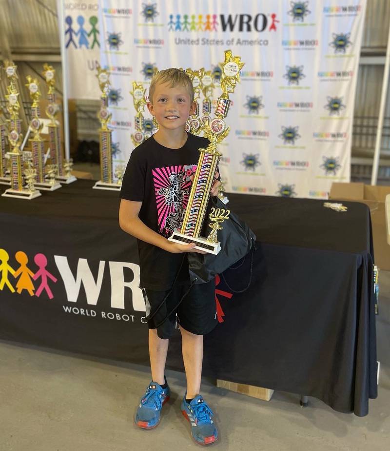 Sawyer Rinn, 10, a fourth grader at Western Avenue School in Geneva, holds his first place trophy in the World Robot Olympiad. Sawyer competed in the Elementary RoboMission category in August and defeated 21 teams in his age group.