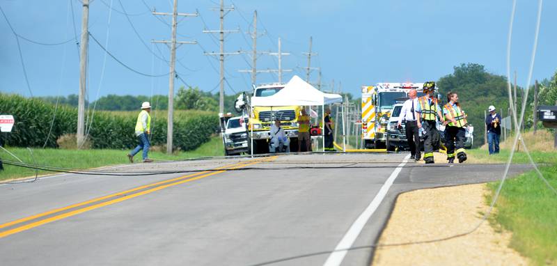 Power lines lay across Illinois Route 64 following a single plane accident near the Ogle County Airport between Oregon and Mt. Morris on Tuesday, July 22, 2025. The pilot of a crop dusting plane was killed after hitting power lines near the airport. A section of Illinois Route 64 was closed for ComEd crews to repair the damage.