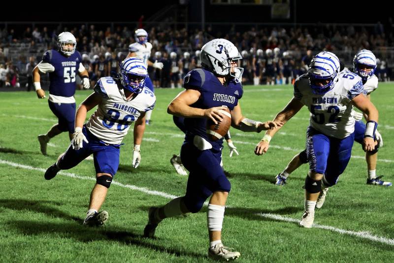 Princeton's Common Green (36) and Ian Morris (52) zero in on Monmouth-Roseville QB Andy Myers Friday night at Monmouth. The Titans upset the Tigers 31-3.