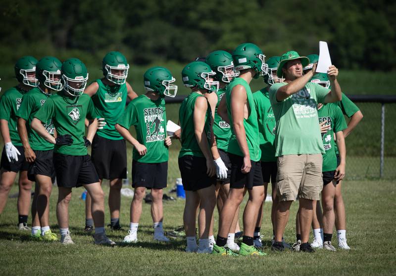 Seneca head coach Terry Maxwell talks with players during the 7 on 7 football at Central High School earlier this summer.