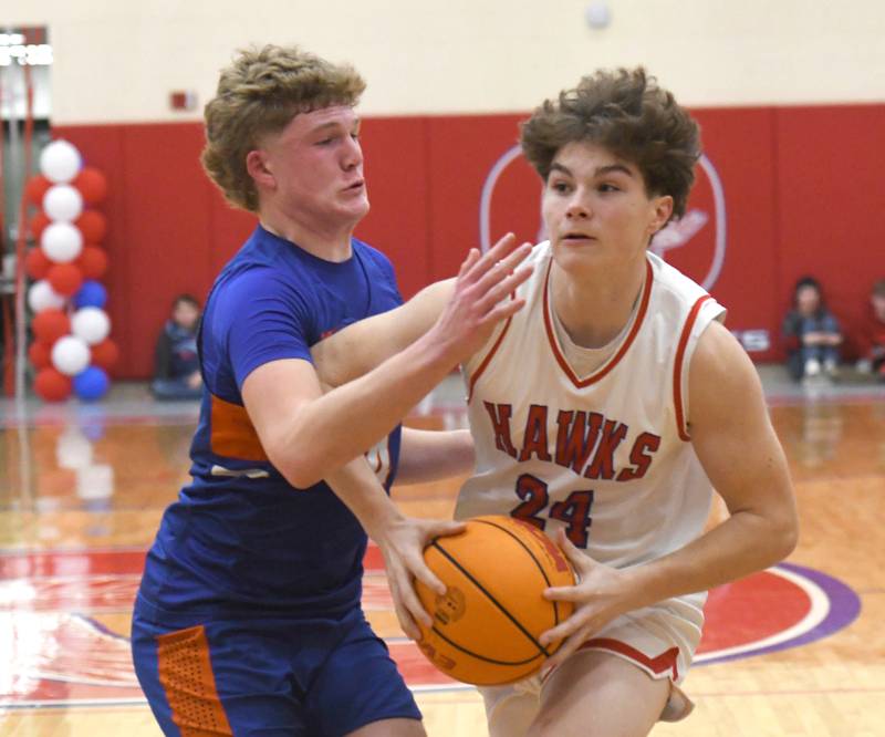 Oregon's Ethan Peeling protects the ball from Genoa-Kingston's Cody Cravatta on Friday, Jan. 30, 2026 at the Blackhawk Center.