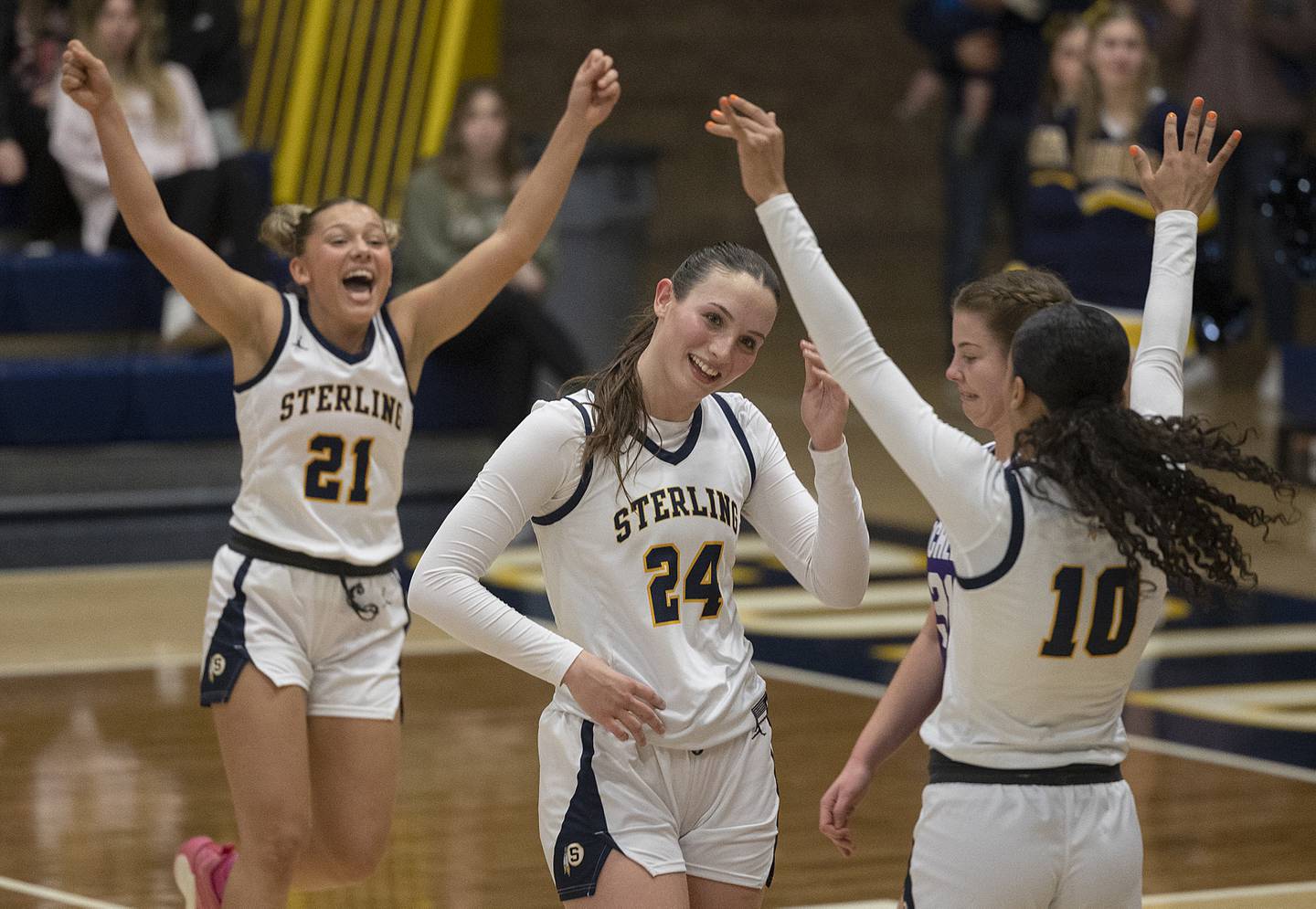 Teammates celebrate Sterling’s Madison Austin after sinking a free throw for her 1,000 career point Monday, Feb. 17, 2025, in a semifinal regional against Rochelle.