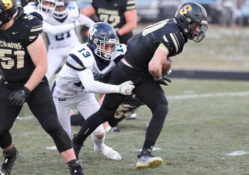 Nazareth's Brady Gorman brings down Sycamore's Zack Crawford Saturday, Nov. 18, 2022, during their state semifinal game at Sycamore High School.