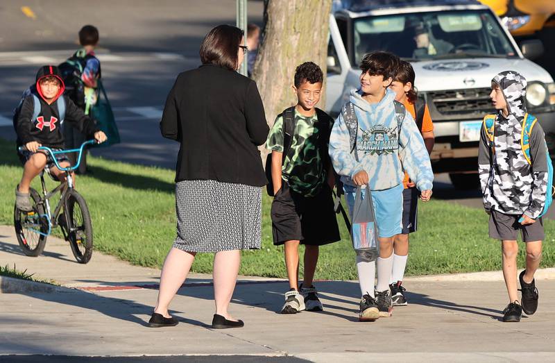 New Genoa Elementary School principal greets students on the first day of school Tuesday, Aug. 16, 2022, in Genoa.