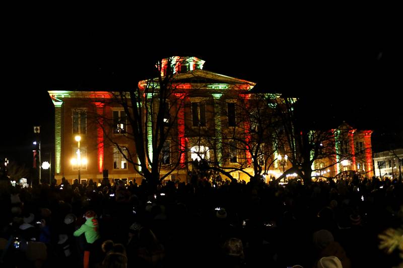The Old Courthouse Center is lit in red in green during the Lighting of the Square Friday, Nov. 24, 2023, in Woodstock. The annual holiday season event featured brass music, caroling, free doughnuts and cider, food trucks, festive selfie stations and shopping.
