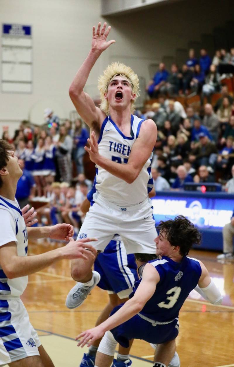 Princeton's Noah LaPorte crashes into Newman's Garrett Matznick in the first half of Tuesday's game at Prouty Gym. He scored 29 points to lead the Tigers to a 59-54 win.