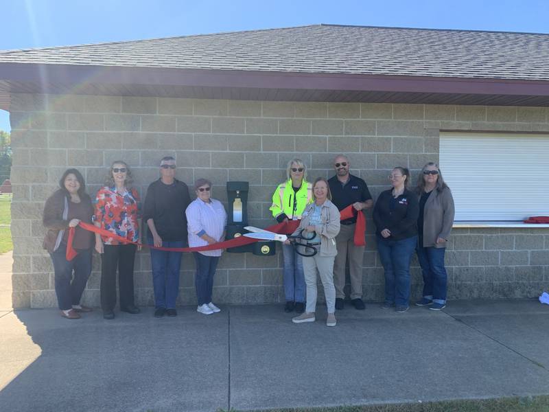 (From left) Tara Bedei, Judy Booze, Julie Ramza, Barbara Ehling, Holly Hunt, Ellen Vogel, Nick McGurk, Amber Miller and Diana Schuler pose for a photo Monday, Oct. 7, 2024, as the new drinking fountain and water filling station opened.