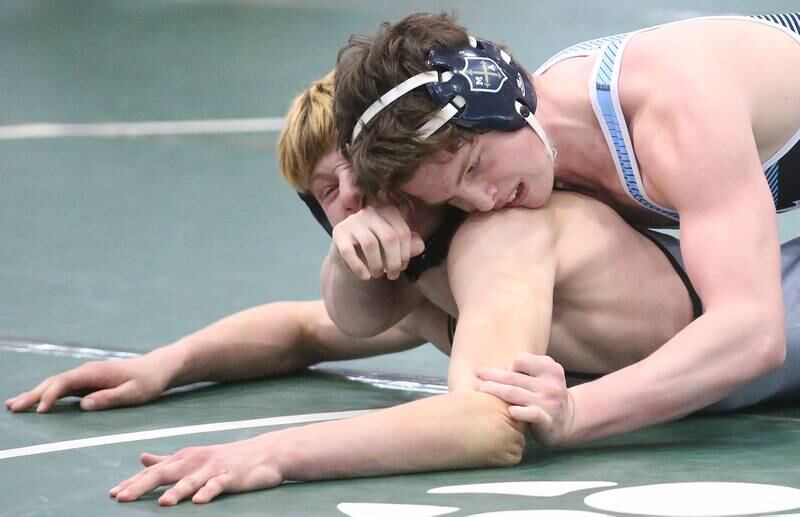 Marquette's Brysen Manly wrestles Sandwich's Joshua Kotalik in the 150 pound weight class during the Class 1A Regional meet on Saturday, Feb. 8, 2025 at St. Bede Academy.