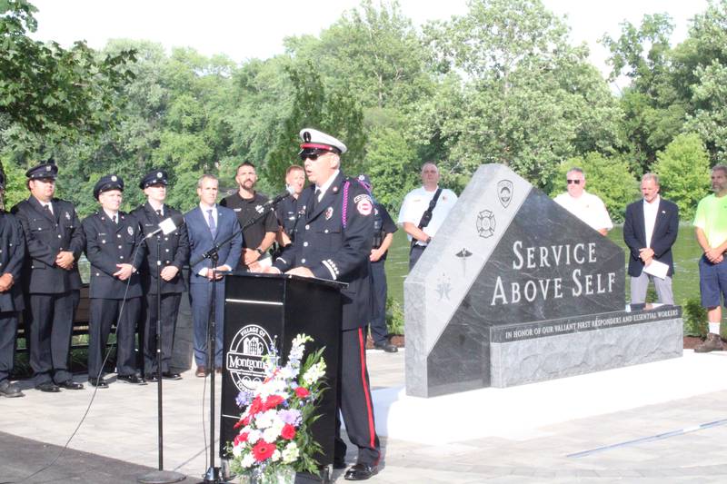 Kris Kearns, Osewgo Fire Protection District Lieutenant speaks before the unveiled first responders and essential workers monument in Montgomery