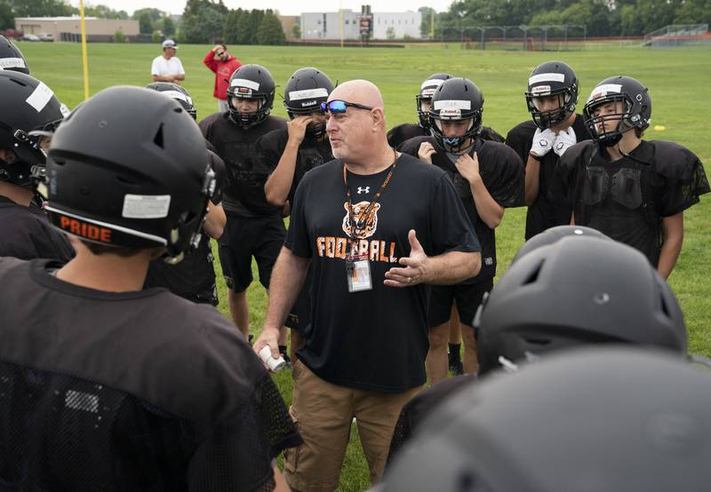 Head coach Jon McLaughlin leads the team during practice for the Crystal Lake Central varsity football team on Wednesday, July 21 at Crystal Lake Central High School in Crystal Lake.