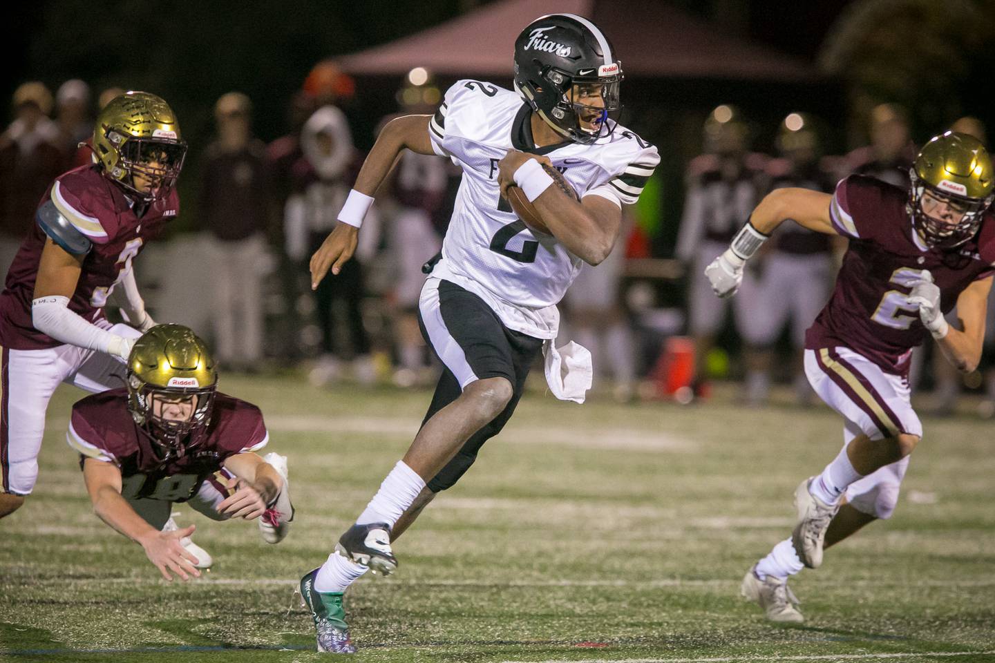 Fenwick quarterback Kaden Cobb (2) runs past St. Ignatius defensive back Jacob Lawler (18) on a touchdown run during the third quarter of the football game at Saint Ignatius College Prep on Friday, Oct. 22, 2021.The Friars won, 28-20.