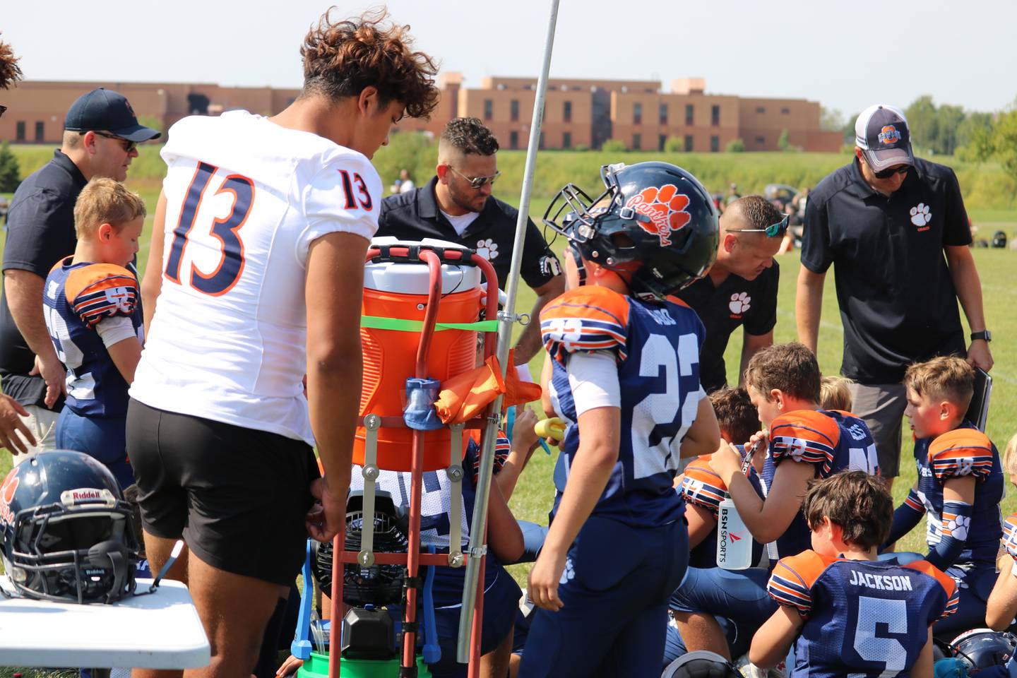 Players from the Oswego High School varsity football team attended an Oswego Youth Tackle Football game to support and encourage a 9U team on Sept. 17 2022.