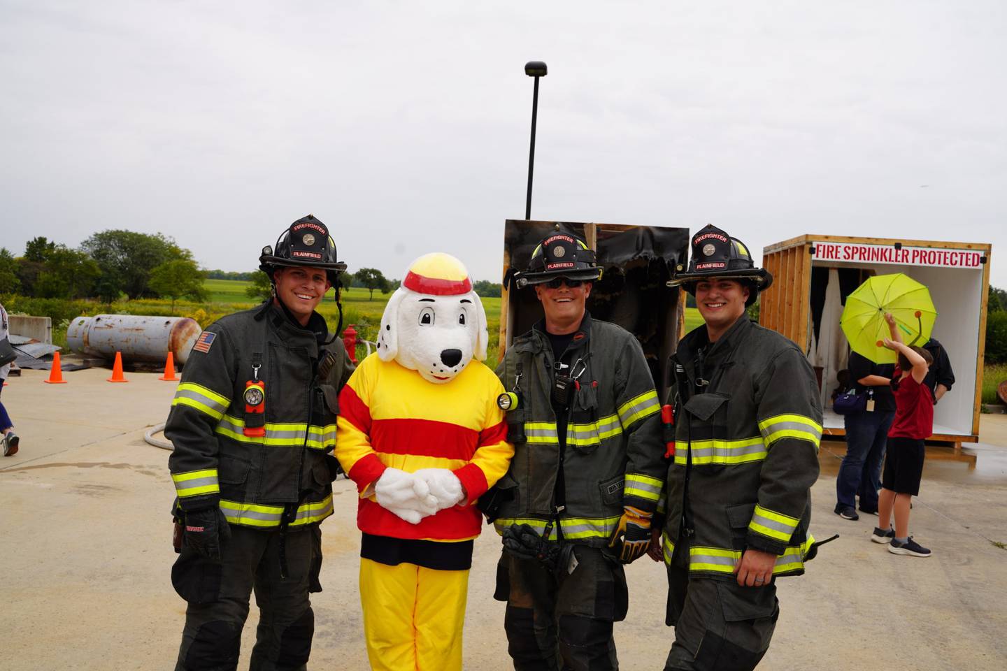 Plainfield firefighters pose with Sparky the mascot at the Plainfield Fire Protection District open house on Saturday, Sept. 16, 2023.