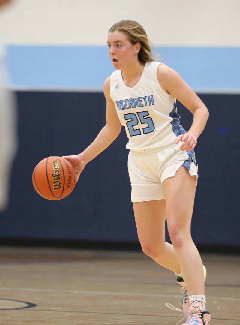 Nazareth's Amalia Dray (25) dribbles during the girls varsity basketball game between Fremd and Nazareth on Monday, Jan. 9, 2023 in La Grange Park, IL.