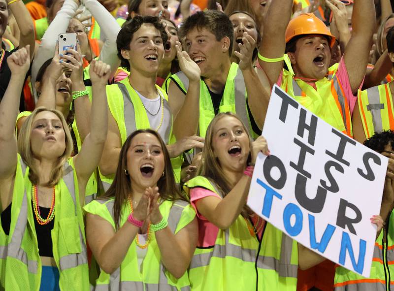 Downers Grove South fans cheer as their team comes onto the field against Downers Grove North on Friday, Sept. 1, 2023.