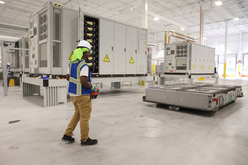 A worker prepares to move an energy-storage system at Gotion Illinois in Manteno on Oct. 1, 2025.