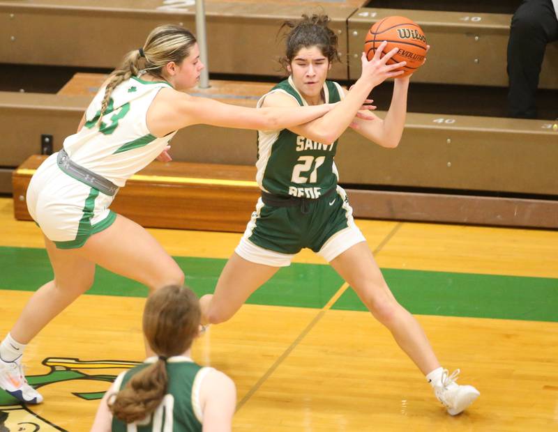 St. Bede's Lily Bosnich looks to pass the ball off to teammate Lili McClain as Seneca's Audry McNabb defends on Monday, Jan. 29, 2024 at Seneca High School.