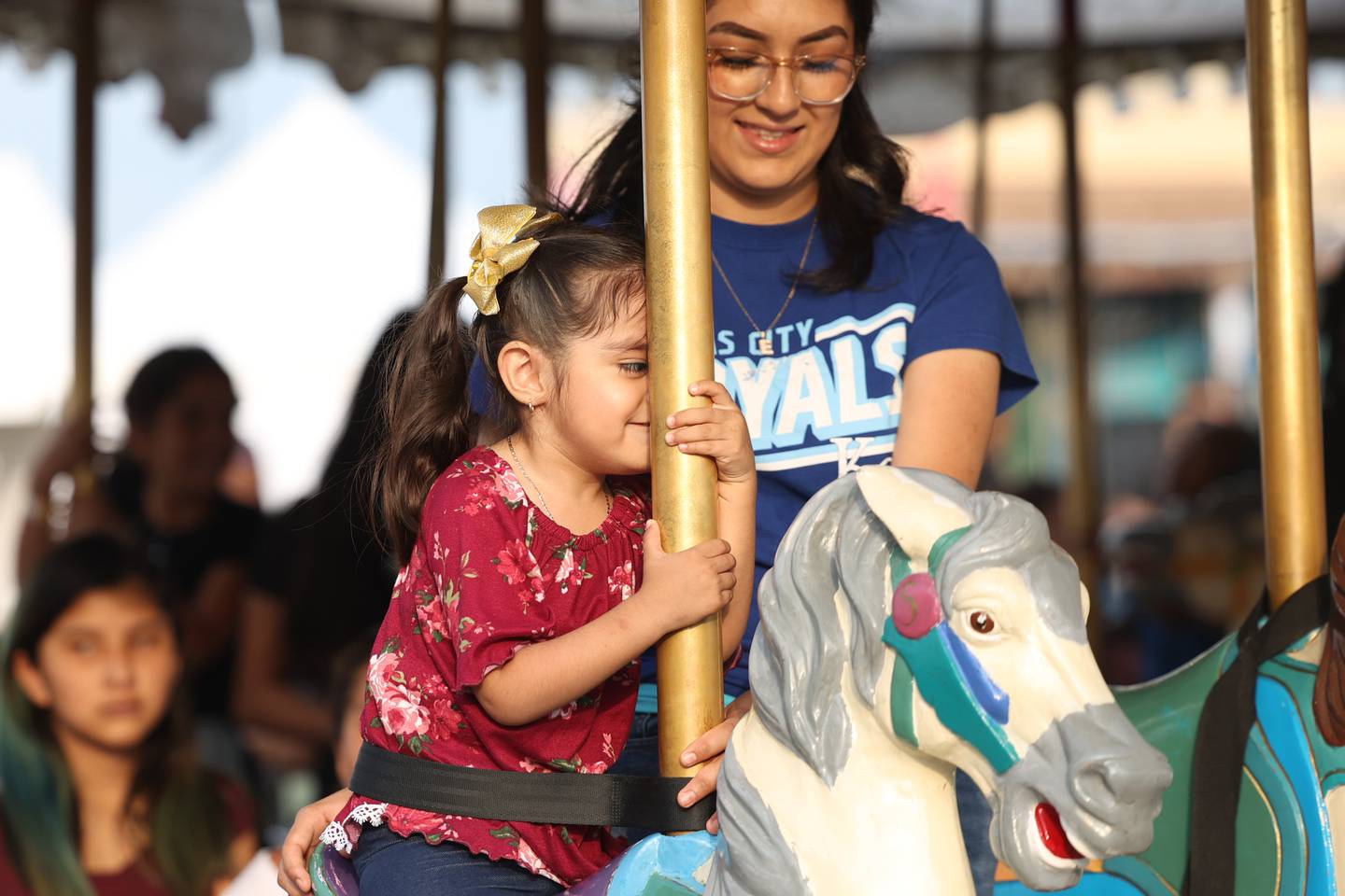 Emili Vieyra holds her daughter, Valentina as she rides the carousel on day 2 of the Taste of Joliet. Saturday, June 25, 2022 in Joliet.