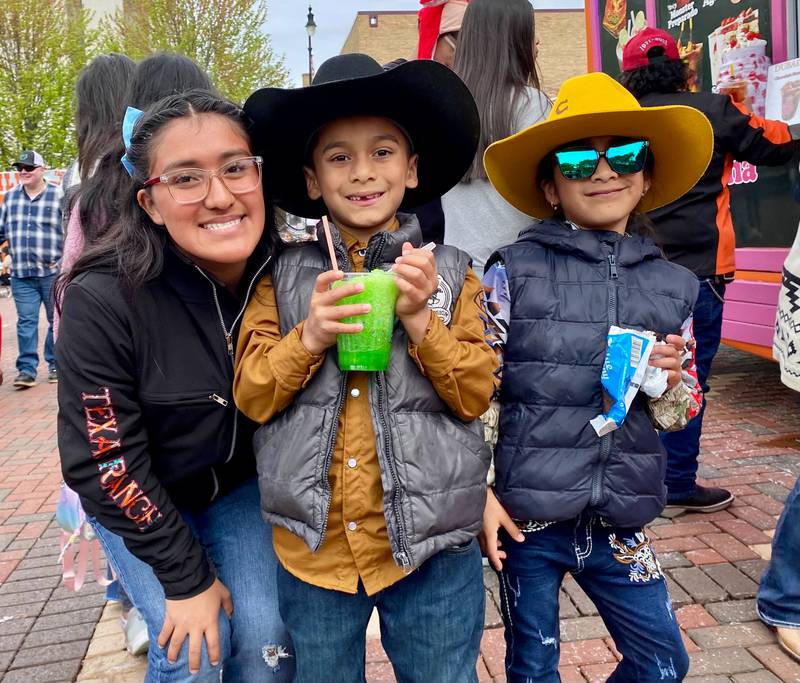 (From left) Siblings Kyara Chavez, 15, and 7-year-old twins Kean Chavez and Kaya Chavez, pose with some sweet treats on Sunday, May 4, 2025, in the Frank Van Buer Plaza in downtown DeKalb for the city's annual Cinco de Mayo Celebration.