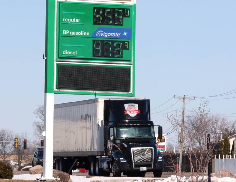 A semi-trailer truck drives by a gas station on Dekalb Avenue in Sycamore Tuesday, March 8, 2022, where gas was $4.59 for a gallon of regular unleaded gasoline. US gas prices hit an all time high this week especially hurting truck drivers and others who have to drive for a living.
