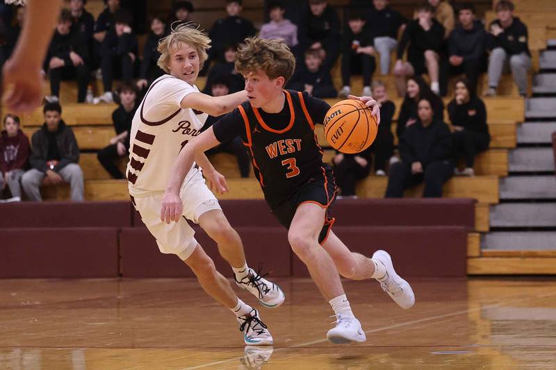 Lincoln-Way West’s Aidan Durkin drives around Lockport’s Nojus Venckus on Friday, Dec. 6, 2024 in Lockport.