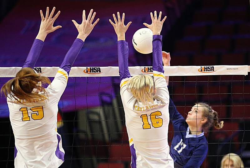 Nazareth Academy's Lauren Salata (17) spike is blocked by Taylorville's Addison Tarr (16) and teammate Mazie Felming (19) in the Class 3A semifinal game on Friday, Nov. 11, 2022 at Redbird Arena in Normal.