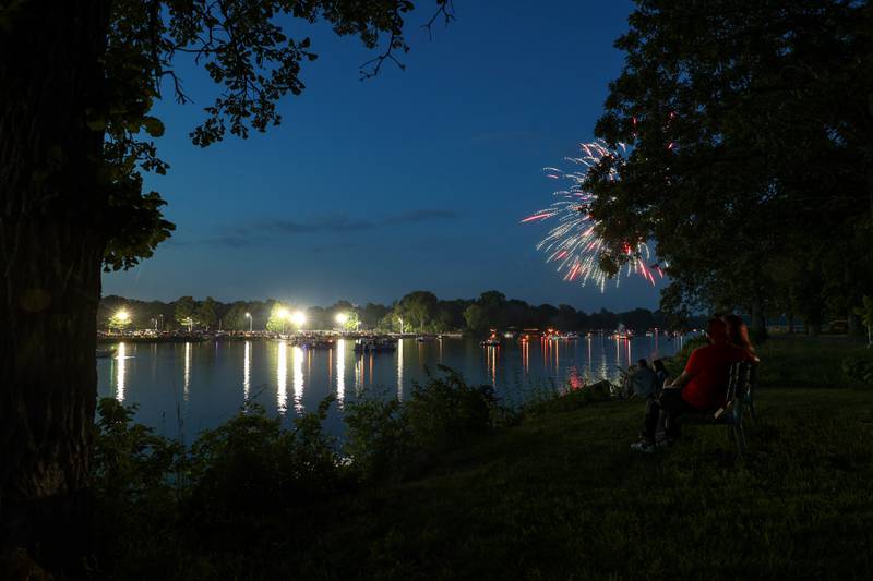Couples look out over the Kankakee River as boats anchor ahead of the city of Kankakee's fireworks show at Kankakee Community College on Friday, July 4, 2025.