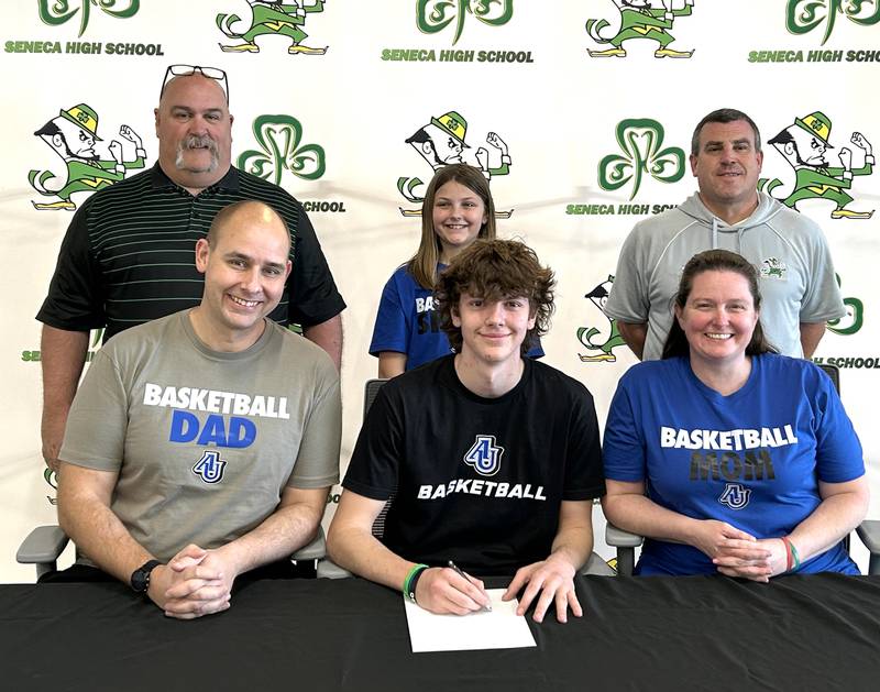 Recent Seneca High School graduate Sebastian Deering has committed to continue his education at Aurora University and his basketball career at the  NCAA Division III level with the Spartans. Deering (seated, at center) is pictured here bookended by parents Jon and Sandy Deering, while standing behind are (left to right) former Seneca coach Russ Witte, Harper Deering and Seneca AD Ted O'Boyle.