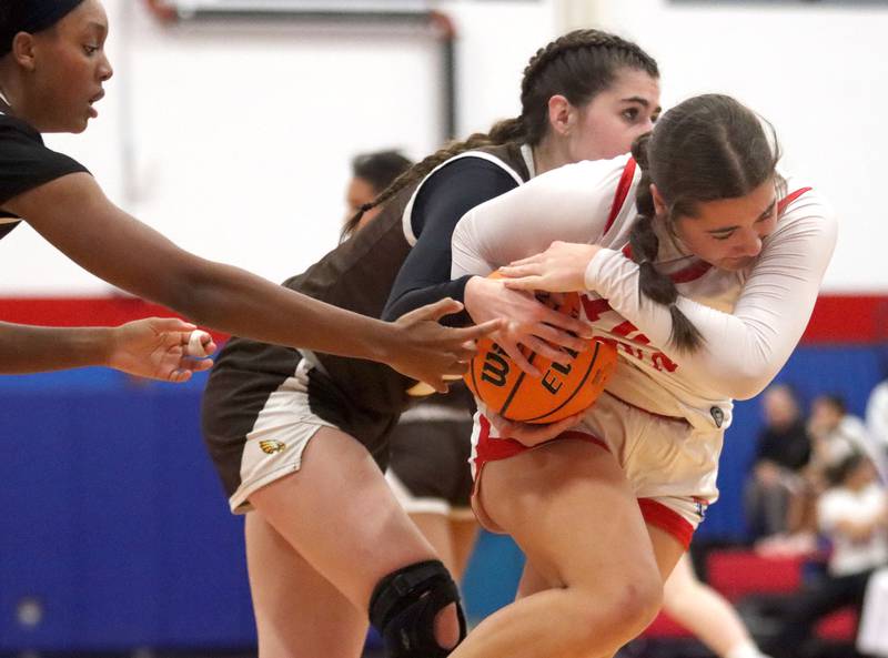 Jacobs’ Olivia Schuster, back, defends Dundee-Crown’s Kate Graham in varsity girls basketball on Friday, Dec. 12, 2025, at Dundee-Crown High School in Carpentersville.