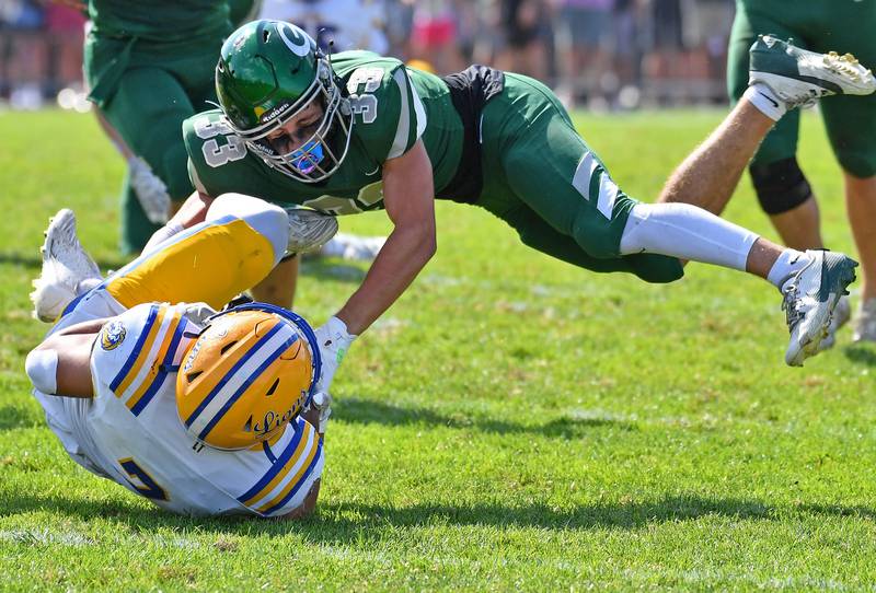 Glenbard West’s MJ Wargin (33) makes a flying tackle of Lyons Township’s Brady Rusk during a game on September 27, 2025 at Glenbard West High School in Glen Ellyn.