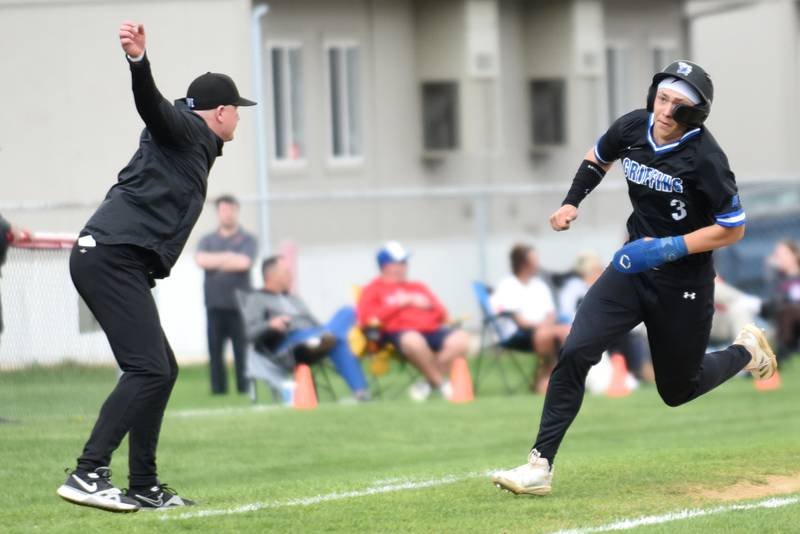 Lincoln-Way East's Evan Riiff, right, is waved around third base by head coach John McCarthy during a game at Bradley-Bourbonnais Friday, Aprul 18, 2025.