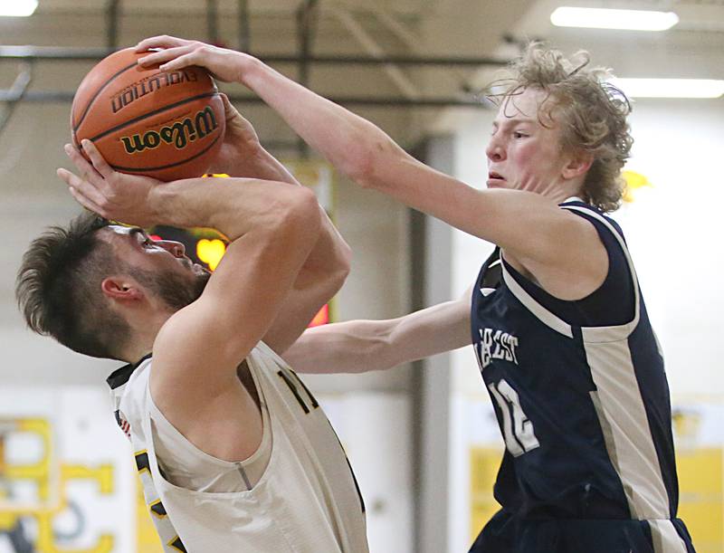 Fieldcrest's Jordan Heider draws a foul on Putnam County's Jackson McDonald on Tuesday, Feb. 7, 2023 at Putnam County High School.